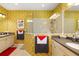 Bright bathroom featuring a walk-in shower, vanity, and cream-colored walls with unique patterned wallpaper at 12019 Sawgrass Lake Ter, Bradenton, FL 34211