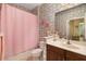 Bathroom featuring whimsical dinosaur wallpaper, a pink shower curtain, and a wooden vanity at 12019 Sawgrass Lake Ter, Bradenton, FL 34211