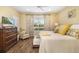 Bright bedroom with a large window, a wooden dresser, and a comfortable seating area at 12019 Sawgrass Lake Ter, Bradenton, FL 34211