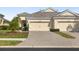 Charming single-story home boasts a well-manicured lawn, paver driveway, and a three-car garage at 12019 Sawgrass Lake Ter, Bradenton, FL 34211
