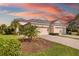 Charming single-story home boasts a well-manicured lawn, paver driveway, and a three-car garage at 12019 Sawgrass Lake Ter, Bradenton, FL 34211