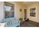 Charming front porch with a blue bench, decorative pillows, and a welcoming entrance at 12019 Sawgrass Lake Ter, Bradenton, FL 34211