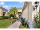 Inviting walkway to home with lush landscaping, a charming bench, and elegant front door at 12019 Sawgrass Lake Ter, Bradenton, FL 34211