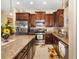 Kitchen featuring granite counters, stainless steel appliances and dark wood cabinets at 12019 Sawgrass Lake Ter, Bradenton, FL 34211