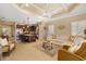 Open concept living room and kitchen area featuring tile floors, light walls and coffered ceilings at 12019 Sawgrass Lake Ter, Bradenton, FL 34211