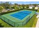 Overhead view of Community tennis court with lush landscape and fencing at 12019 Sawgrass Lake Ter, Bradenton, FL 34211