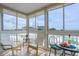 Inviting balcony with comfortable chairs and a table, showcasing scenic views of the sky, beach, and ocean at 1255 Tarpon Center Dr # 315, Venice, FL 34285