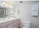 Bright bathroom with a vanity, mirror, towels, and toilet at 1255 Tarpon Center Dr # 315, Venice, FL 34285