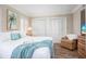 Well-lit bedroom with plank floors, shutters, a view, and closet space at 1255 Tarpon Center Dr # 315, Venice, FL 34285