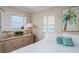 Bright bedroom featuring a beach view, shutters, a dresser, and coastal decor at 1255 Tarpon Center Dr # 315, Venice, FL 34285