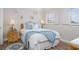 Charming bedroom with coastal decor, a wicker nightstand, and a comfortable bed at 1255 Tarpon Center Dr # 315, Venice, FL 34285