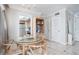 Dining area with a round glass table, wooden chairs, and a view into the kitchen, with a storage unit at 1255 Tarpon Center Dr # 315, Venice, FL 34285