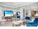 Cozy living room featuring mirrored walls, comfortable seating, and a flatscreen television displaying a beach scene at 1255 Tarpon Center Dr # 315, Venice, FL 34285