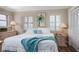 Bright and airy bedroom with white bedding, shuttered windows, and serene decor, creating a relaxing retreat at 1255 Tarpon Center Dr # 315, Venice, FL 34285
