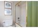A shower and bathtub area with gold trim and a shower curtain at 1255 Tarpon Center Dr # 315, Venice, FL 34285