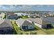 Community aerial view showcasing the neighborhood's layout, backyard views, and a lake at 13540 Old Creek Ct, Parrish, FL 34219