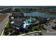 Aerial view of a community clubhouse with pool, manicured landscaping, neighborhood, and lake views at 13540 Old Creek Ct, Parrish, FL 34219