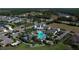 Aerial view of a community clubhouse with pool, manicured landscaping, and neighborhood homes at 13540 Old Creek Ct, Parrish, FL 34219