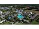 Aerial view of a community clubhouse with pool, manicured landscaping, and neighborhood homes at 13540 Old Creek Ct, Parrish, FL 34219