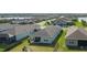 Backyard aerial view showcasing the community's layout, lakeside homes, and fenced in backyards at 13540 Old Creek Ct, Parrish, FL 34219