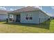 A spacious backyard featuring a covered patio, sliding glass doors and a well-maintained lawn at 13540 Old Creek Ct, Parrish, FL 34219