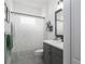 Well-lit bathroom with a sleek vanity, gray cabinets, modern fixtures, and a shower with patterned curtain at 13540 Old Creek Ct, Parrish, FL 34219