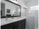 Modern bathroom with double vanity sinks, a large mirror, and a shower with glass panel at 13540 Old Creek Ct, Parrish, FL 34219