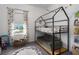 Charming bedroom featuring a modern bunk bed with a built-in couch underneath and dinosaur-themed decorations at 13540 Old Creek Ct, Parrish, FL 34219