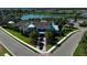 Aerial shot of the clubhouse with beautiful landscaping, a lakeside view, and meticulous walkways at 13540 Old Creek Ct, Parrish, FL 34219