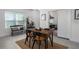 Bright dining room with a rustic table and chairs, complemented by a decorative bench at 13540 Old Creek Ct, Parrish, FL 34219