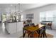 Dining area with a rustic table, seamlessly connected to the kitchen and living spaces at 13540 Old Creek Ct, Parrish, FL 34219