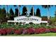 A decorative entrance sign with vibrant flowers that reads Canoe Creek 'Love Where Life Leads' at 13540 Old Creek Ct, Parrish, FL 34219