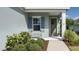 Close-up of a front door featuring a wreath, window with shutters, and landscaped yard at 13540 Old Creek Ct, Parrish, FL 34219