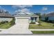 Charming single-story home featuring a well-manicured lawn and a two-car garage at 13540 Old Creek Ct, Parrish, FL 34219
