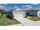 Well-maintained home with a lush front yard, a two-car garage, and a neatly paved driveway at 13540 Old Creek Ct, Parrish, FL 34219
