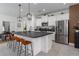 Modern kitchen with stainless steel appliances, a large island, and stylish pendant lighting at 13540 Old Creek Ct, Parrish, FL 34219