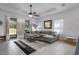 Inviting living room boasts a large sectional sofa, a modern coffee table, and sliding glass doors at 13540 Old Creek Ct, Parrish, FL 34219
