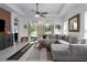 Bright living room featuring tile floors, a large sectional sofa, and access to the backyard at 13540 Old Creek Ct, Parrish, FL 34219
