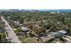 Aerial view of a residential area featuring a blue house nestled among lush greenery at 1367 21St St, Sarasota, FL 34234