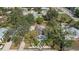 An aerial view of a blue home with a red door, surrounded by lush trees and palm trees at 1367 21St St, Sarasota, FL 34234