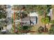 Aerial view of a home with a concrete driveway and a cozy patio under a large umbrella at 1367 21St St, Sarasota, FL 34234