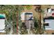 Aerial view of a home with a concrete driveway and a cozy patio under a large umbrella at 1367 21St St, Sarasota, FL 34234