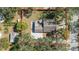 Aerial view of a home with a concrete driveway and a cozy patio under a large umbrella at 1367 21St St, Sarasota, FL 34234