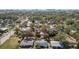 Aerial view of a single-Gathering home, outlined in red, nestled among lush greenery and neighboring houses at 1367 21St St, Sarasota, FL 34234