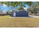 The house has a blue backyard, a wide paved area and a white door at 1367 21St St, Sarasota, FL 34234