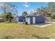 A house with a blue backyard, a wide paved area and a white door at 1367 21St St, Sarasota, FL 34234