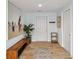 Inviting entryway with wood-look flooring, a rustic bench, and bright, neutral decor at 1367 21St St, Sarasota, FL 34234
