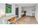 Inviting entryway with wood-look flooring, white walls, and a desk illuminated by a modern lamp at 1367 21St St, Sarasota, FL 34234