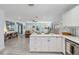 Open-concept kitchen with white cabinetry and quartz countertops overlooks the cozy living area at 1367 21St St, Sarasota, FL 34234