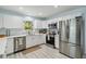 Bright kitchen with white cabinets, stainless steel appliances, and a window over the sink at 1367 21St St, Sarasota, FL 34234